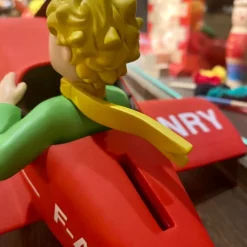 Tirelire le Petit Prince dans son avion